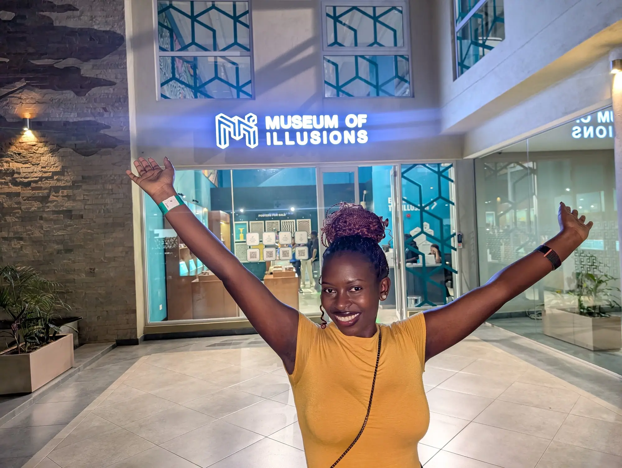Museum of Illusions Nairobi. Arms up, illusion pending.